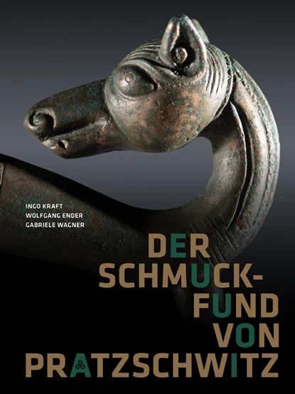 Das Buchcover zeigt ein Detail der Maskenfibel: Das Endstück mit einem nach links gekehrten Hunde- oder Wolfskopf.